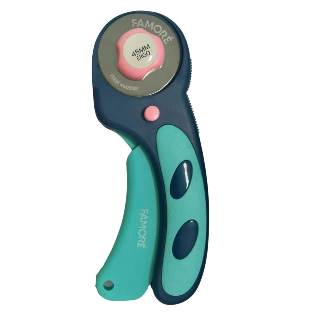 A Famore rotary cutter with a dark blue and teal handle, featuring a pink button and a silver blade housing with a pink dial.